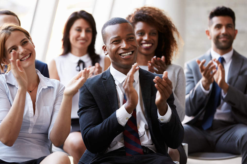 Audience Applauding Speaker at Business Conference